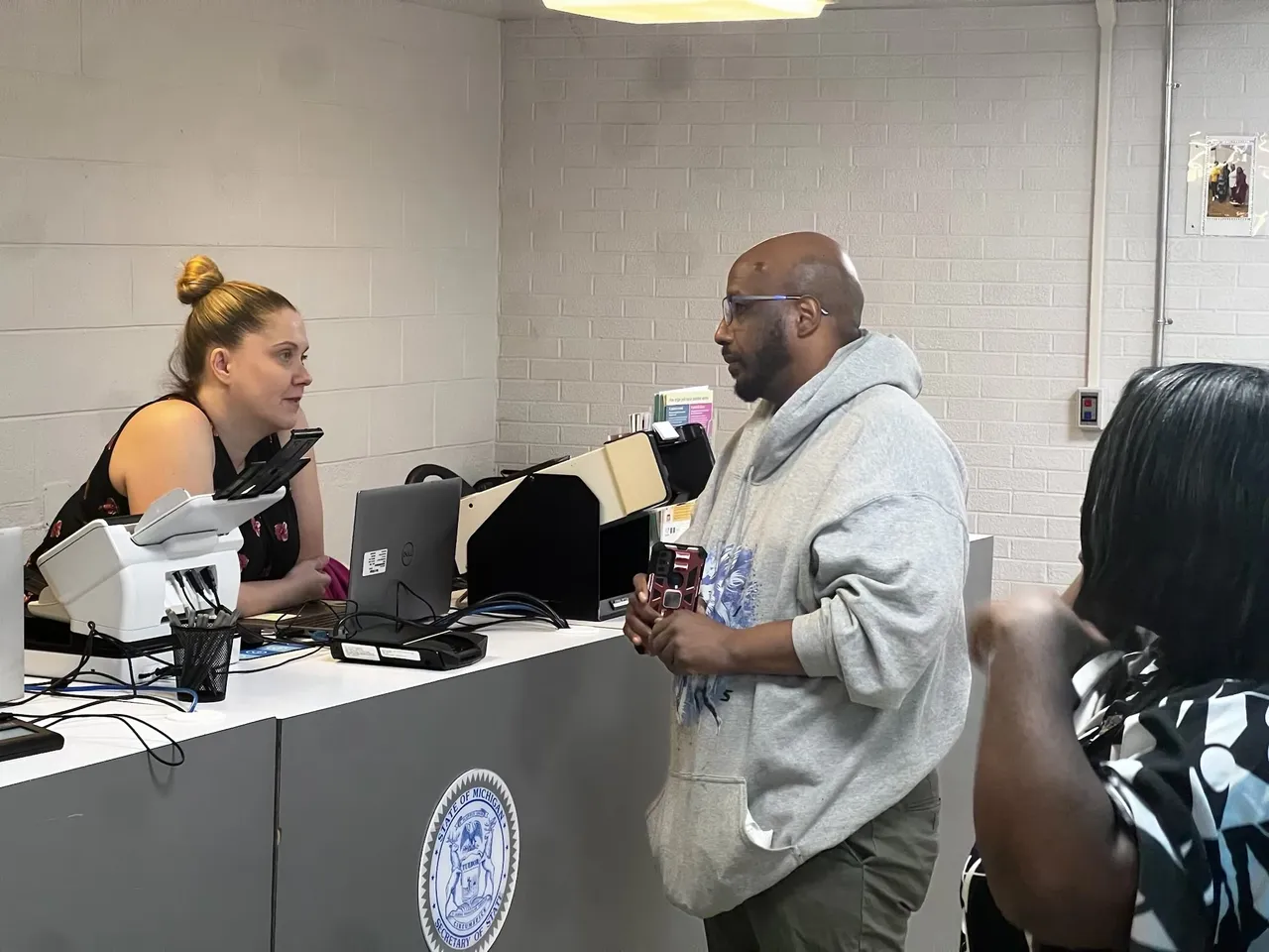 A man standing at the counter of a store.