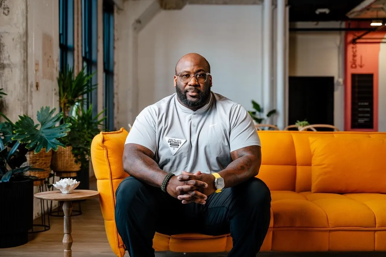 A man sitting on top of a yellow couch.