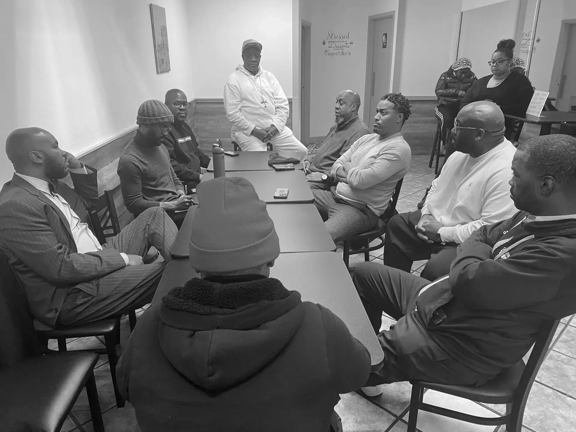 A group of men sitting around a table.