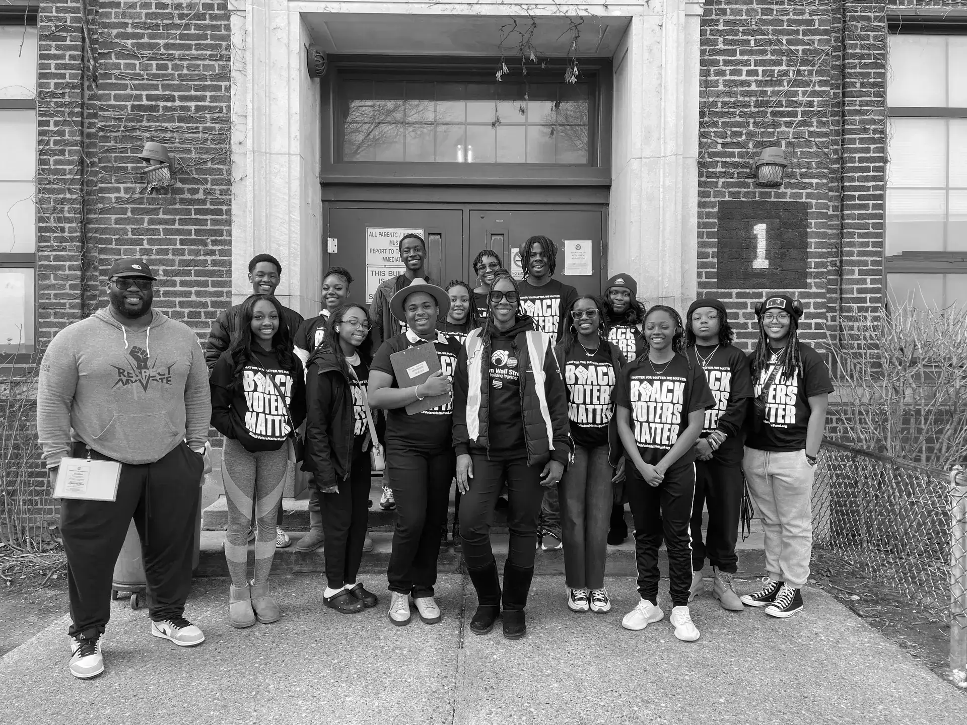 A group of people standing in front of a building.