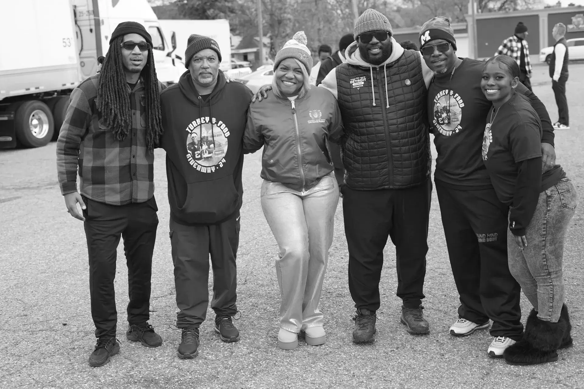 Group of six smiling adults outdoors
