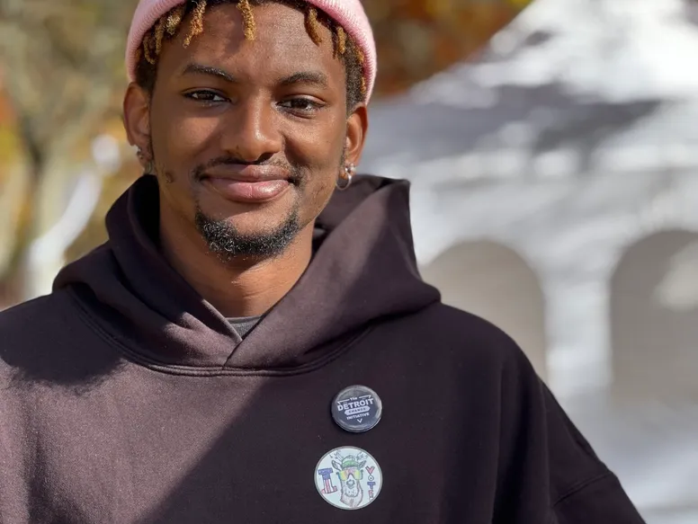 A man with dreadlocks wearing a black hoodie.