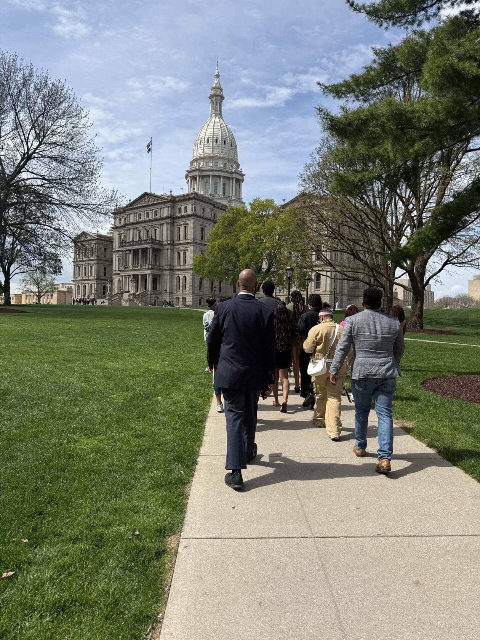 People walking toward domed capitol building