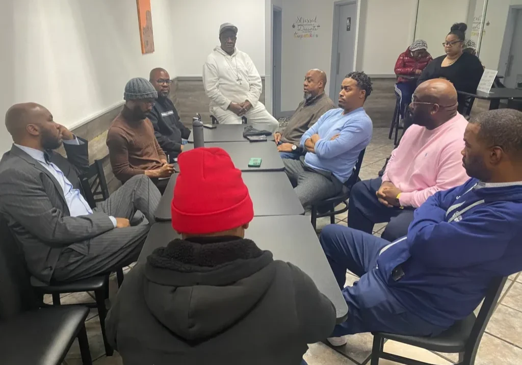 A group of people sitting around a table.